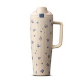 Owala Birthday Bash Coral Cabana 30oz FreeSip Tumbler; cream body with subtle vertical stripes scattered with small navy blue seashells, starfish, coral, and sea urchin illustrations, matching cream flip cap, lid, and side handle